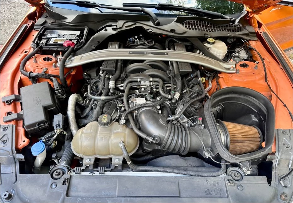 Orange Mustang engine bay before Engine Bay Detail