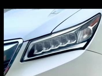 White vehicle headlight after detailing